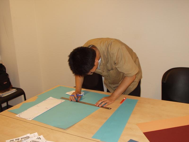 Our chief architect Wei Xing cutting the cardboard paper.