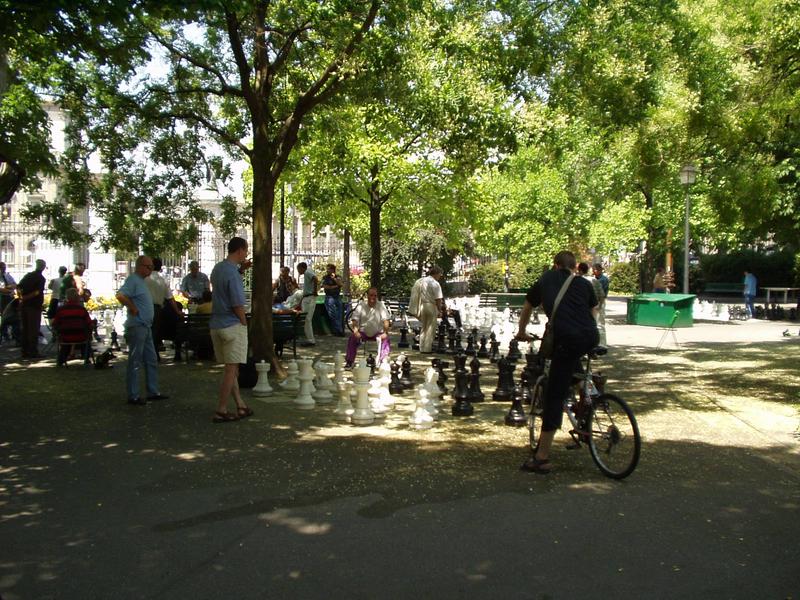 A giant chess board in the middle of the park.