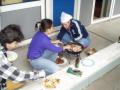 Andrea and Paige take care of the BBQ, while Clauido eats